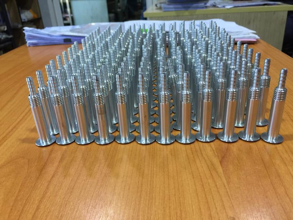 Rows of turned metal pins in volume