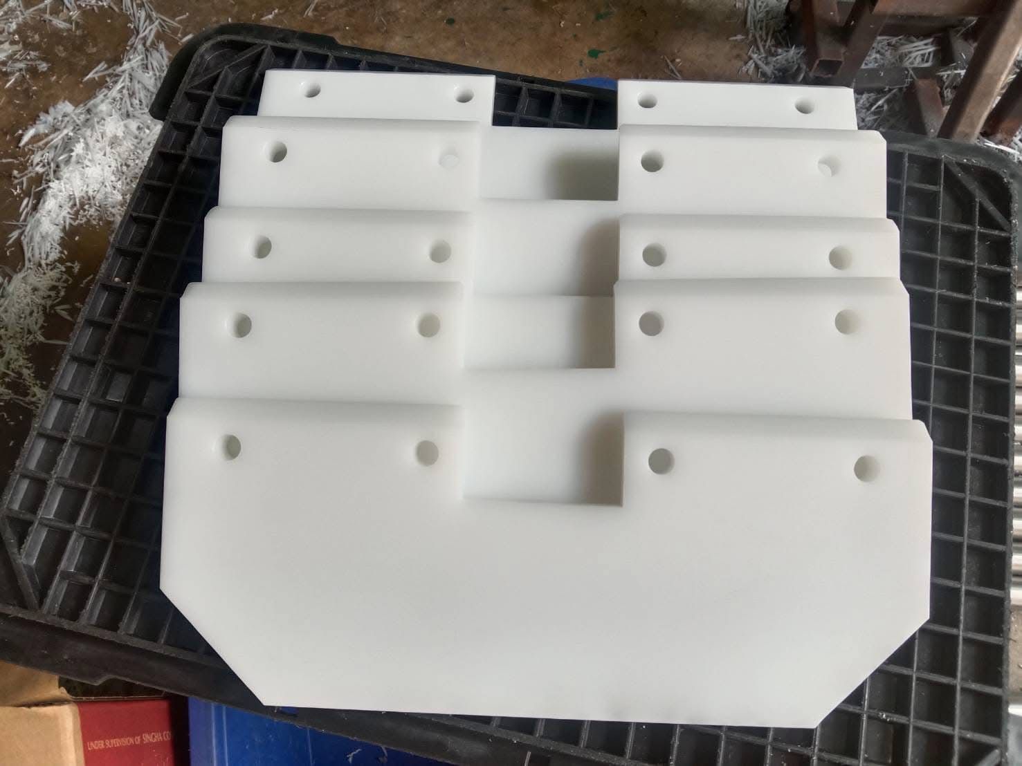 White plastic parts milled to drawing