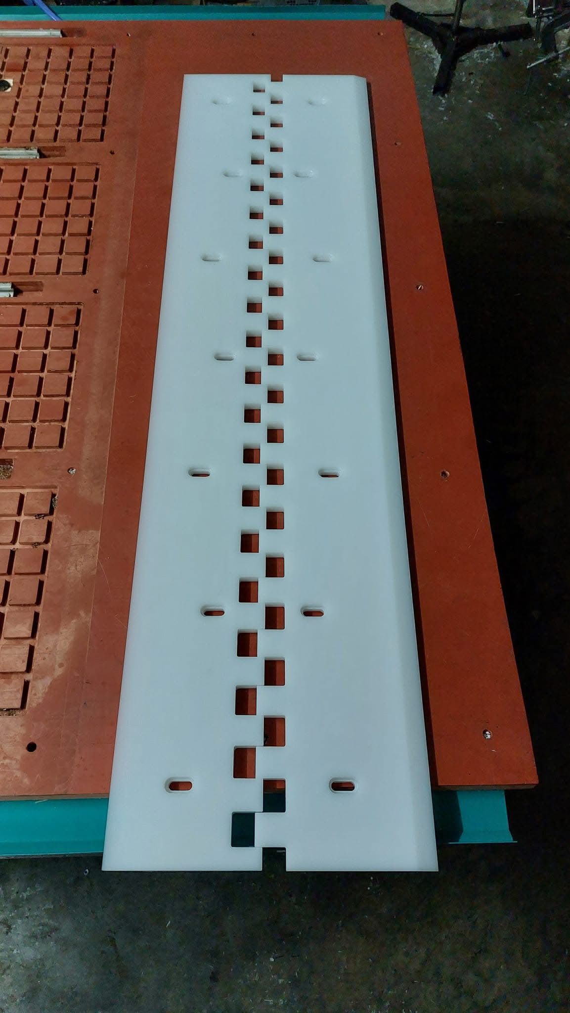 Long plastic jig plate with drilled holes